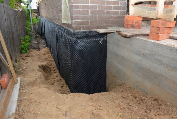 SJ Waterproofing Pros technician performing targeted Exterior Waterproofing assessment in McFarland, WI